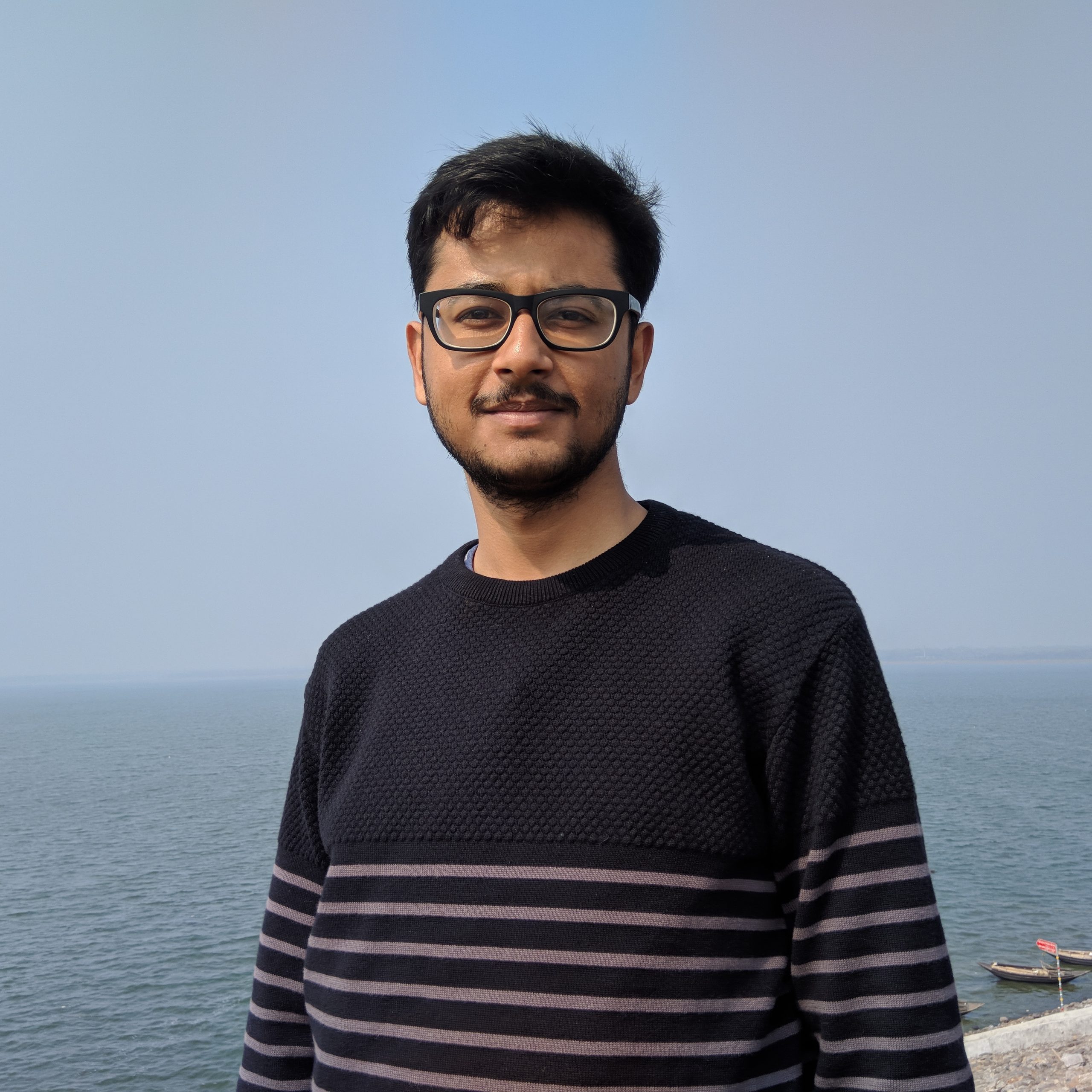 portrait-man-eyeglasses-standing-sea-against-sky